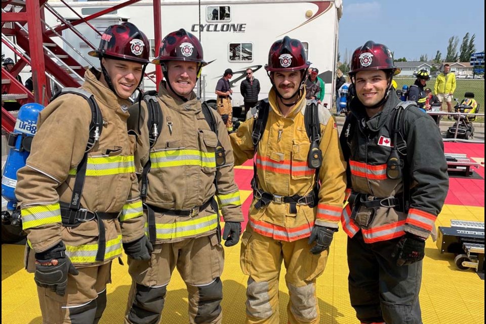 Assiniboia firefighters wearing special helmets created for them for the Fire Fit competition, done by Chuck’s Collision Centre. 