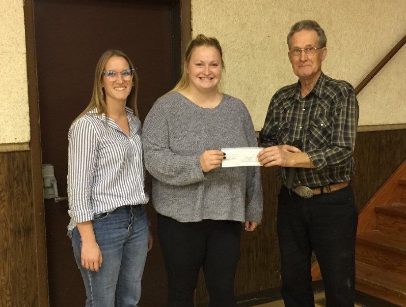 Emily Saunders and Jillian Orchard of Little Sprouts Early Childhood Learning Centre accept a $1,000 donation from Borden Friendship Club, presented by Ed Neufeld. 