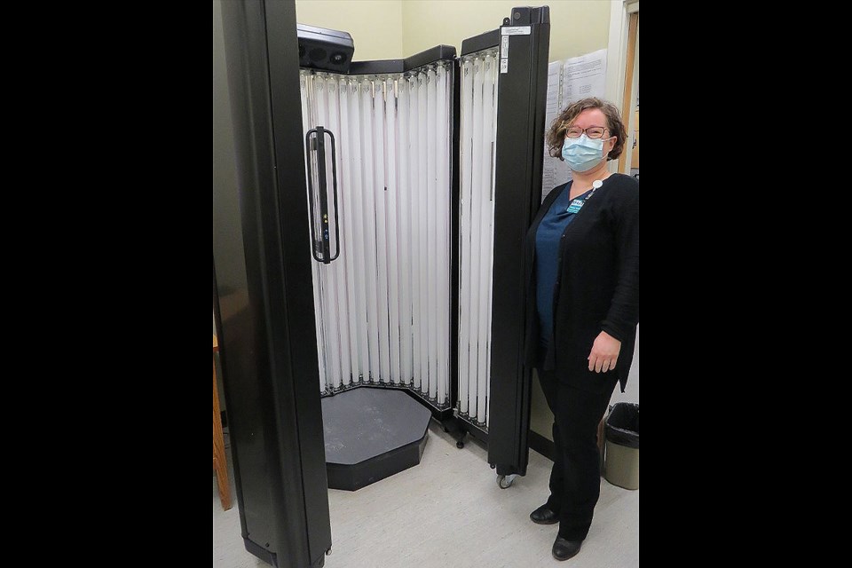 Shauna McGifford, BUH Foundation fund development officer, with the photo therapy unit purchased for BUH. 