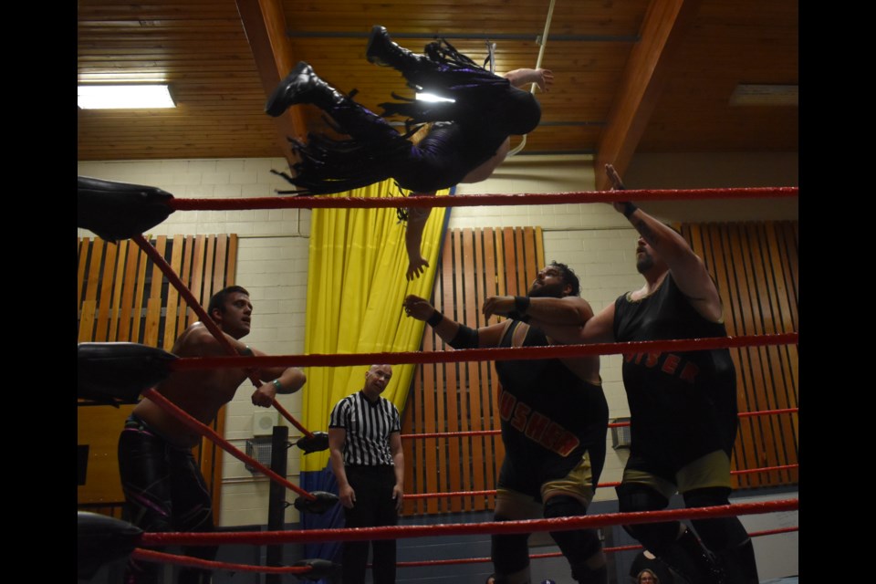 Levi Night hits a crossbody on Kevin O'Doyle and AJ Sanchez