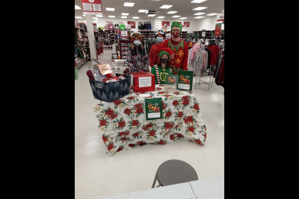 Enthusiastic young volunteers were busy collecting donations and helping youngsters enjoy the colouring contest at the annual Fill The Sleigh Day at Red Apple in Canora on December 11. From left, were: (standing) Aubrie Monette, Chance Weinbender and Josh McLeod, and (seated) Daylia Lukey. / Jocelyn Weinbender
