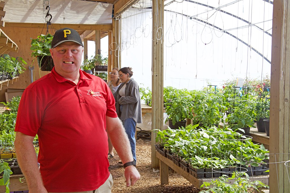 David Larre, owner of Bosers Greenhouse, in front of his busy greenhouse.