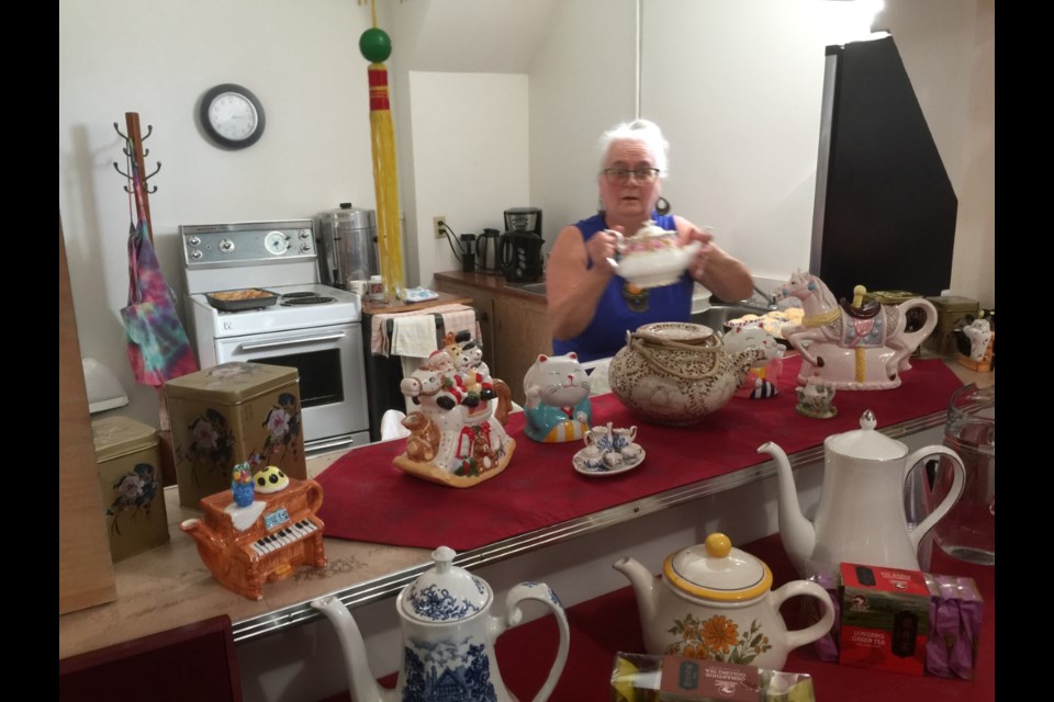 Some of the teapots on display for World Day of Prayer with Brenda Tumbach ready to serve. 