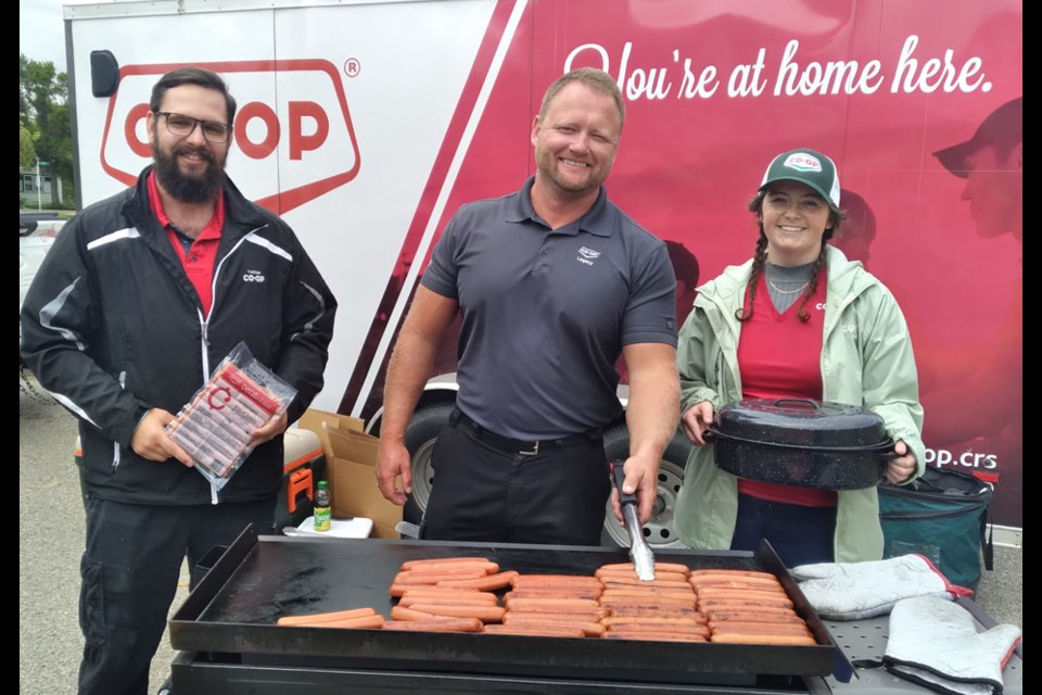 At the grill barbecuing wieners for hot dogs at the Legacy Co-op food store in Kamsack on Aug. 22, were Dillon Zulkavich of Melville, Richard Burym of Yorkton and Zoë Williams of Yorkton.