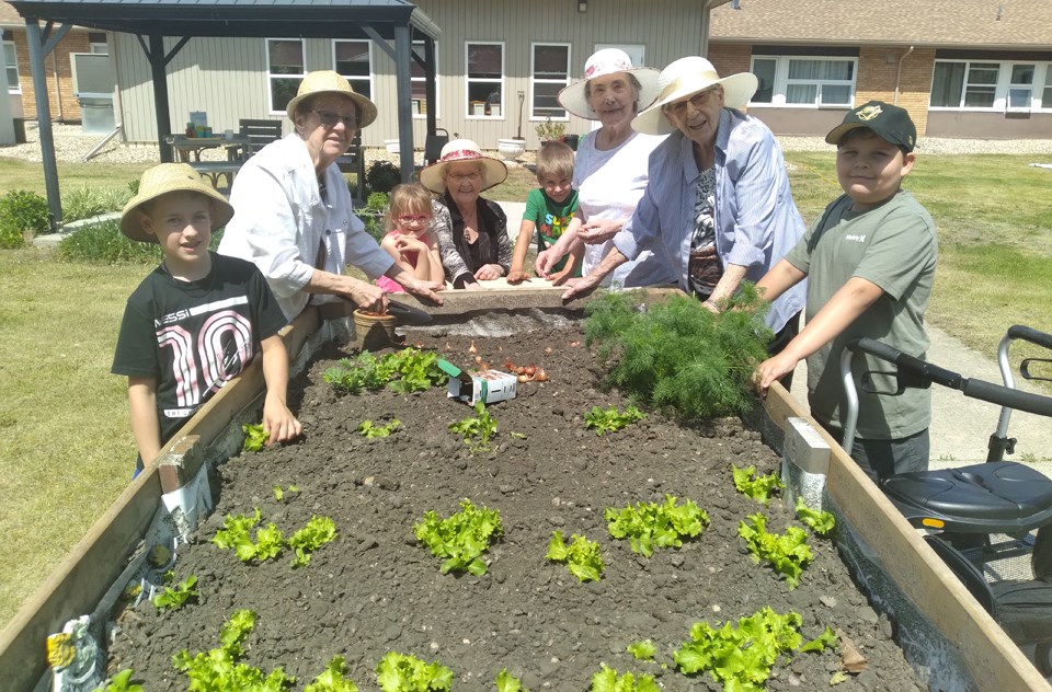At work planting one of the raised gardens at Eaglestone Lodge May 28, are Levi Leis, Eileen Chutskoff, Amara Barrowman, Beverley Scobie, Carter Bates, Gladys Zrudlo, Winnie Koroluk and Jaden Shingoose.