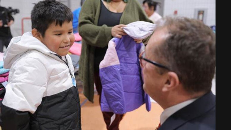 A young member of a First Nations band in Fond-du-Lac, northern Saskatchewan, reacts warmly to his new coat delivered December 4, 2023 by State Deputy Larry Packet and Knights of Columbus members from Saskatchewan – part of the Coats for Kids program. 