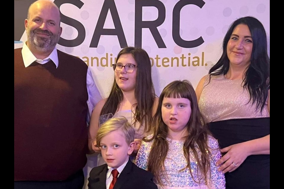Conrad and Kandyce Meili with their children Olivia, Emily and Max at the SARC Award presentation. 