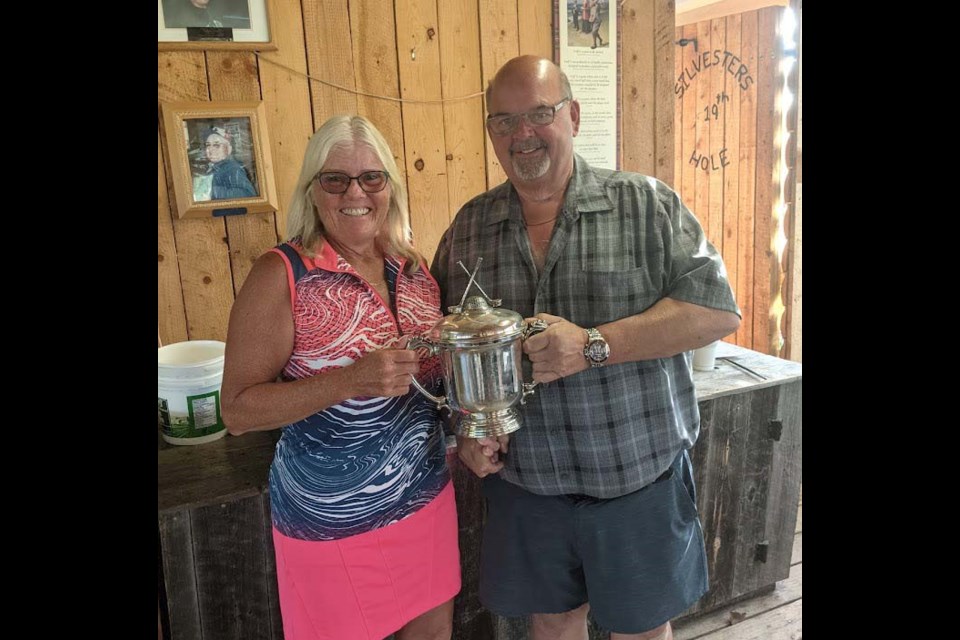 Linda May, who had the overall low score in the ladies’ event of the Meota Golf Course club championship event, with tournament sponsor Brian Woytiuk. 