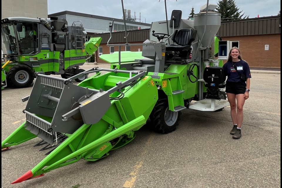 Former Shaunavon resident Auburn Thienes is in her third year as a summer student at the centre. One of her assigned tasks has been to assist with harvest on the miniature combine harvester, riding in the side seat to bag samples for laboratory testing. 
