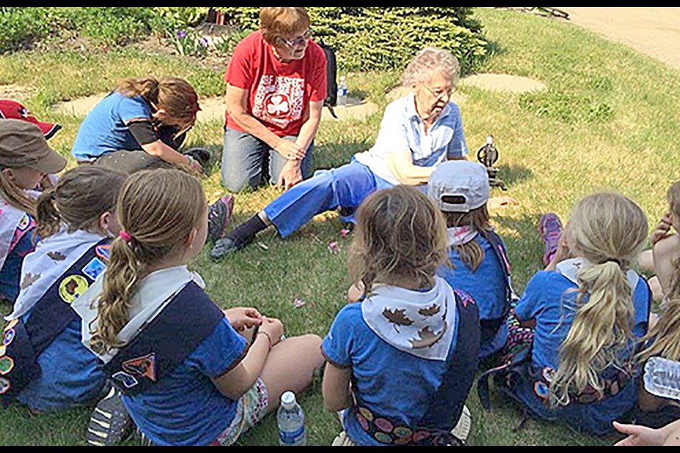 Daphne McLaren showing Maidstone Brownies her toy sewing machine.