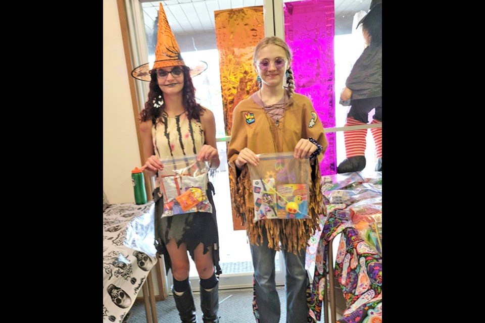 Brinley and Saidai handed out a treat bag and a toy bag to each of 280 children who came to Howl’oween Spook’tacular at Maidstone Seniors’ Drop In Centre.