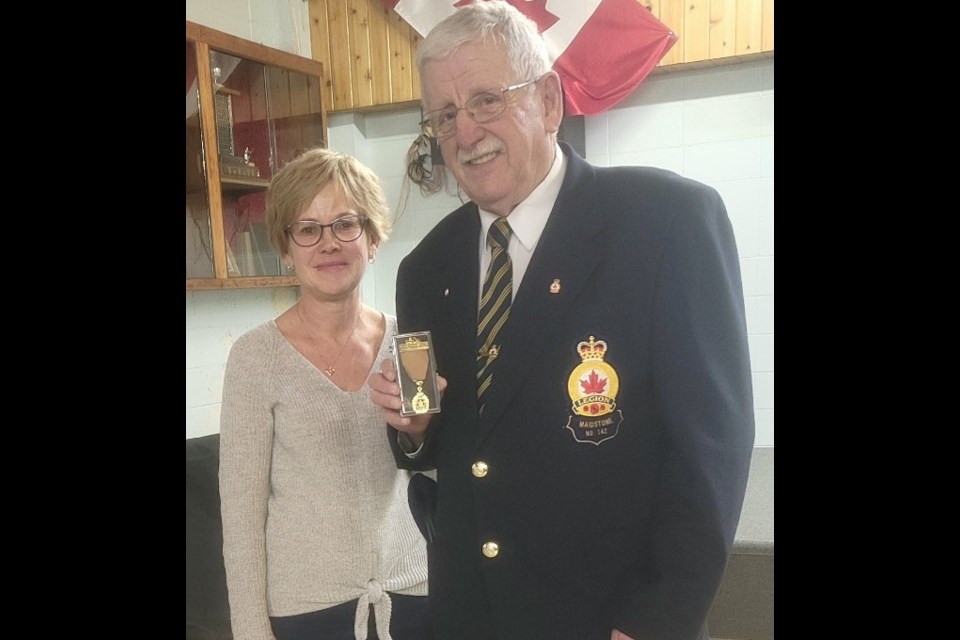 Inga Grimley presents a 50-year service pin and Golden Anniversary Medal to Dennis Noble, president of Maidstone Legion Branch No. 142 Dec. 11. 