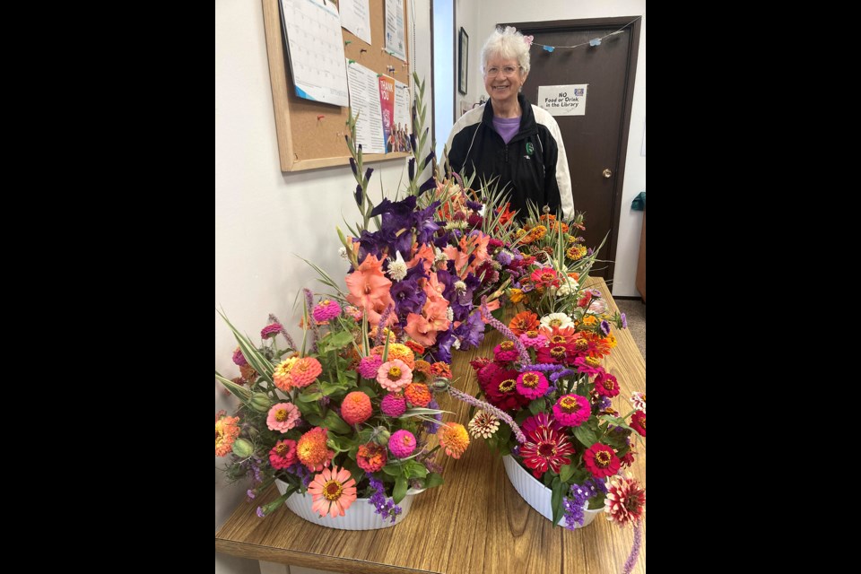 Ruth Bilanski of Hafford with a display of some of her gorgeous floral arrangements at Mayfair’s sale in the local library. 