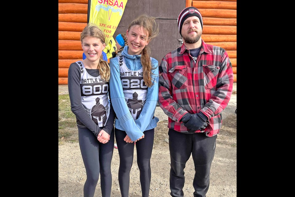Maymont Central School cross-country runners Anneka Harder and Emmerson Voegeli with coach Ryan Nickell at BattleWest Districts in Spiritwood where they earned second and third place finishes. 