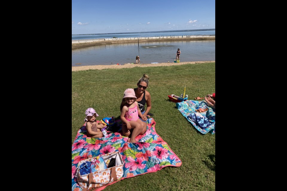 Roxanne Welford and her two daughters Raegan and Ryann taking in the sun at the Meota pool.