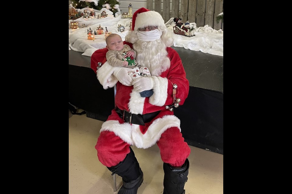 Santa Claus with Kayce, son of Brieanne Russell, at Meota Steak Pit's Santa Day Saturday. 