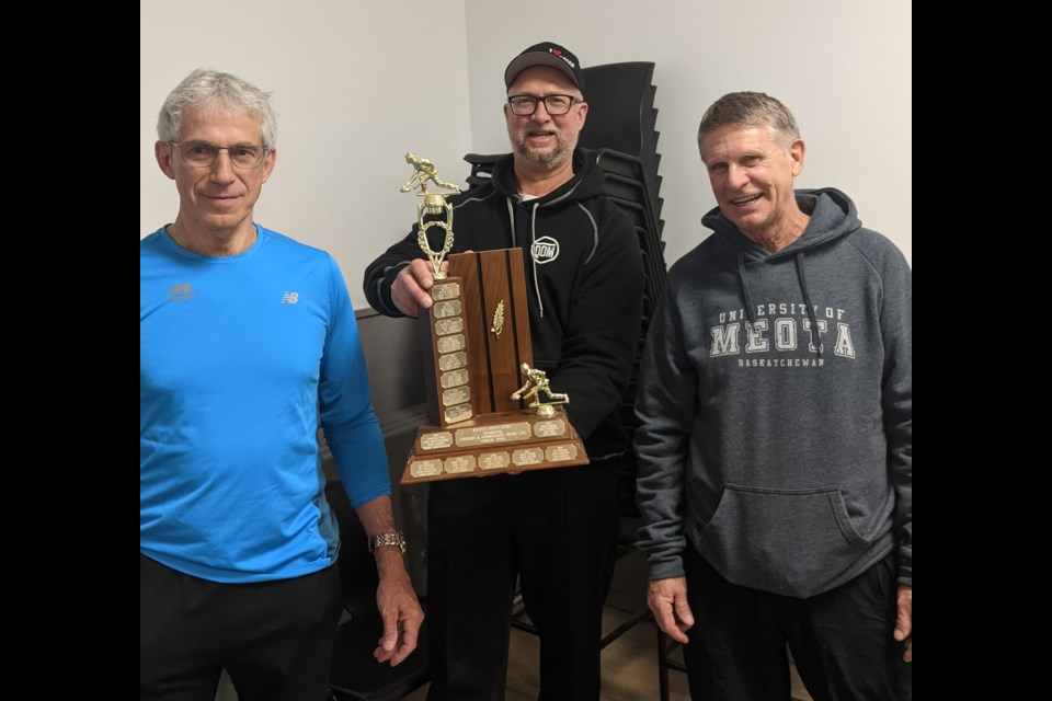 Robert St. Amant and Ed Cadrain, winners of Pool A in the Meota Curling Club sturling bonspiel, with Pat Mohr.