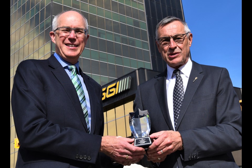 SGI President and CEO Andrew Cartmell (left) and Minister Responsible for SGI Don Morgan (right) with the MADD award.