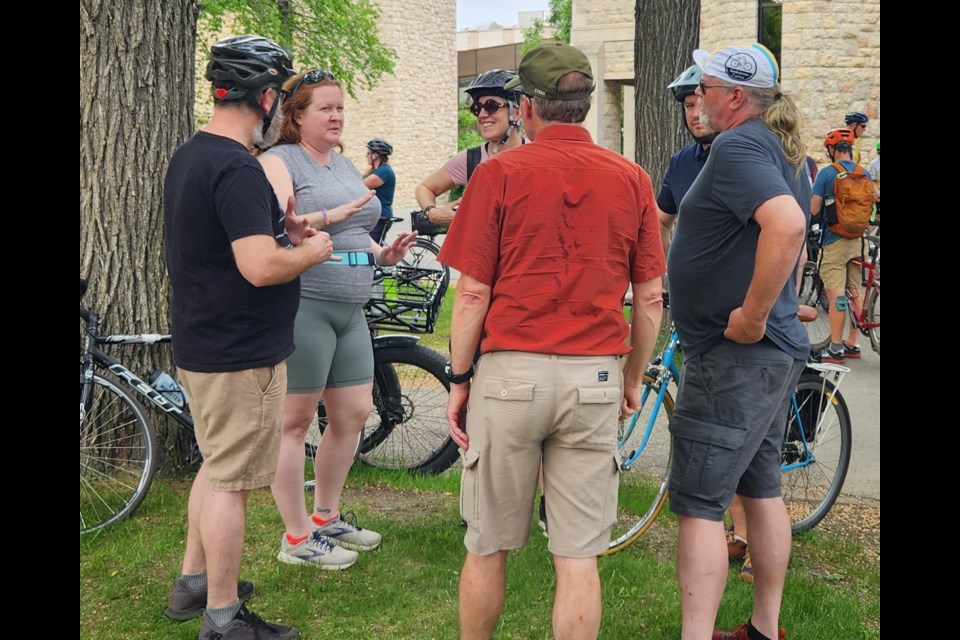 Shoshana Green, second left, talks to some of the people who helped organize the bike ride memorial.
