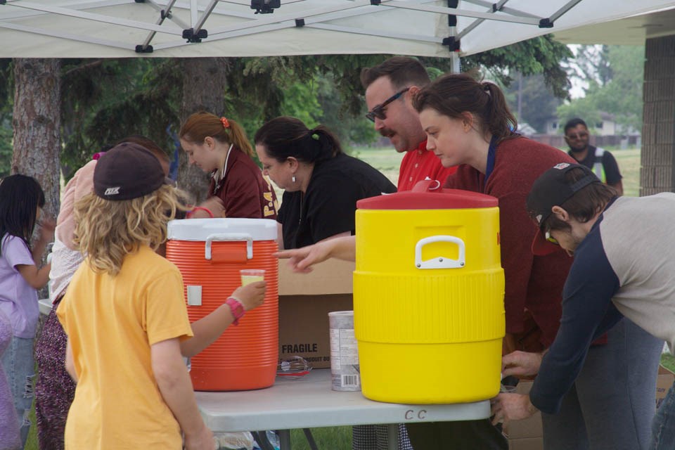 Enjoying the food and beverages offered up during a community barbecue June 4 at Centennial Park.