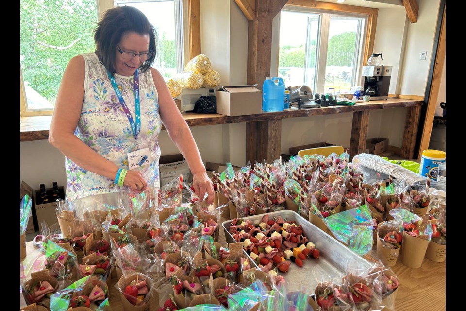 A busy volunteer in the main kitchen at Ness Creek Country Music Festival this past weekend. 