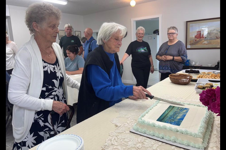 As Do Drop In’s oldest senior at 92, Rose Delainey was honoured to cut the Do Drop In anniversary celebration cake. The cake even had a photo of the new sign on top. 
