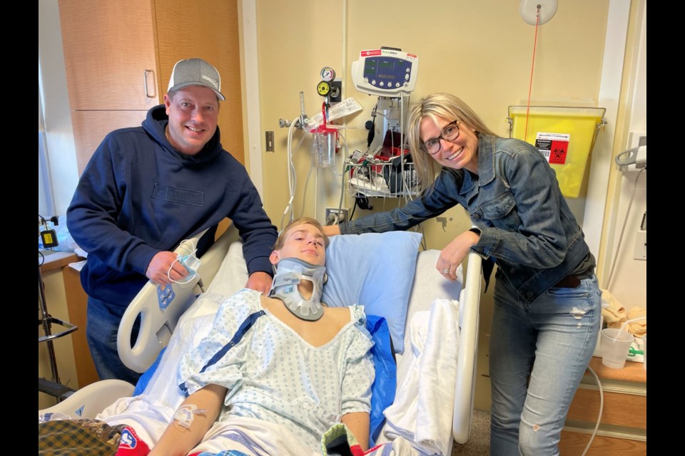 Sandy Cooper-Black in the spinal care ward at Foothills Medical Centre, after breaking his neck in a rodeo accident. With him are stepdad Dan Black and mother Glenice Cooper-Black.
