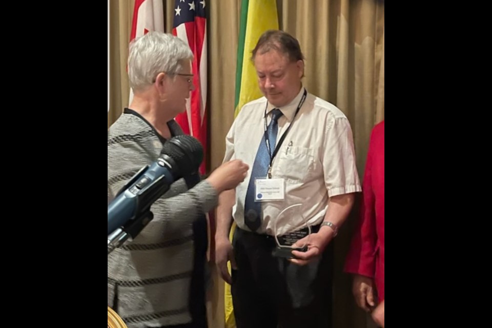 Thomas Schwab is awarded the Saskatchewan Lions Hall of Fame pin and plaque by Past District Governor Marianne Kramchinsky. 