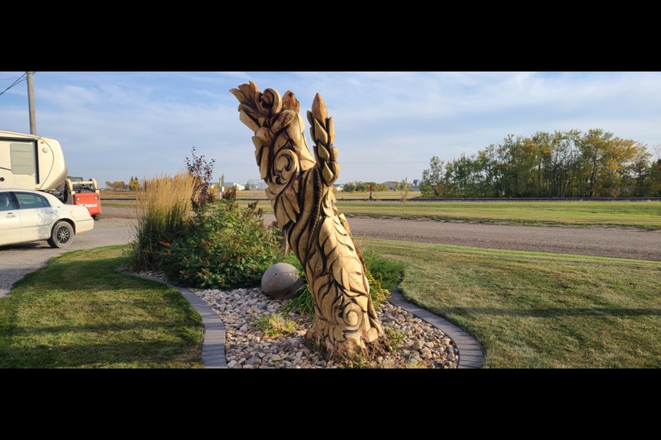 This sculpture is in front of Lori and Duncan Brown’s house. It was carved by Kamron Garbe with KG Woodcraft of Regina. A skilled carpenter and chiseler, Garbe spends most of his time carving sculptural works by hand, power carving antler, and chainsaw carving.