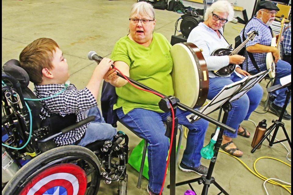 Isaiah Evans added his own touch to a performance by "Billarney", at a recent fundraiser event for his family; a new fundraiser event is slated for Saturday, Sept. 30 at Exhibition Hall, with a market opening at 10 a.m., and the latest SpiderMan movie at 7 p.m.