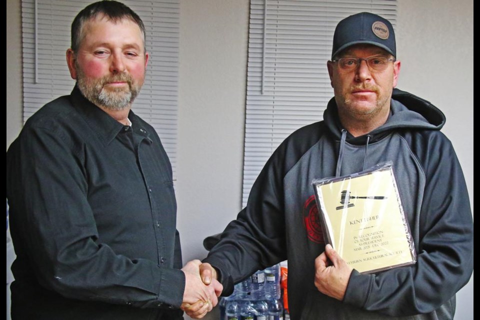 Incoming Ag Society president Tyler Metheral presented Kent Fisher with the gavel award, as he finished his two-year term as president, at the AGM on Wednesday evening.