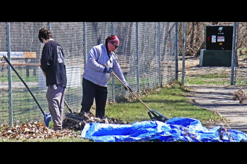 Jayden Stang and Amanda Wegner worked on raking up leaves along the fence at the Weyburn Therapeutic Animal Park on Saturday.