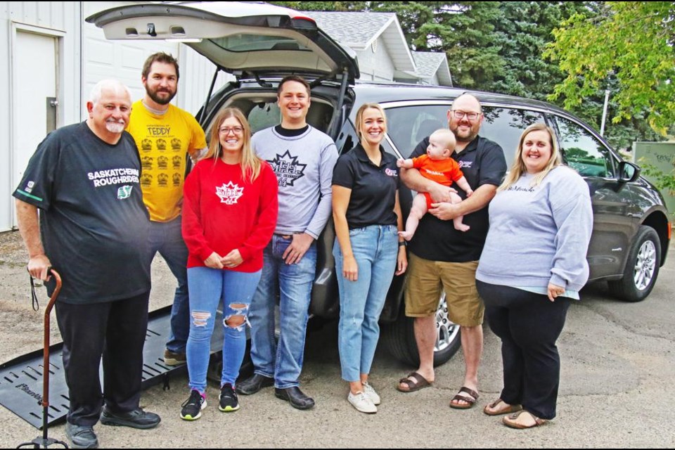 Members of the Weyburn Kin Club gathered with Myron Fletcher of the Weyburn Care-A-Van Society on Saturday, as the Kinsmen Foundation provided a grant of $40,000 towards the purchase of this van through Telemiracle. This 2022 Chrysler Caravan replaces a 2013 van, and is available for rent for anyone who needs to transport someone in a wheelchair. From left to right are Myron Fletcher, and from the Kin Club, Adrian Prybylski, Marie Reeve, Chad Paice, Becky Blackburn, Sean Olson with baby Kinley, and Rebecca Olson.