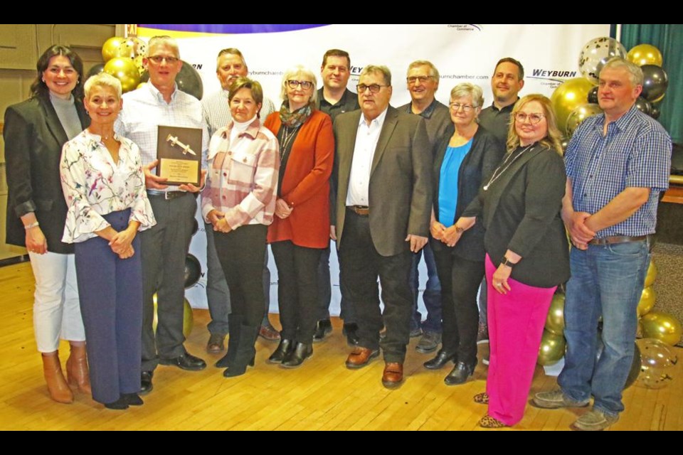 Duane Walkeden, recipient of the 2024 Golden Spike Award from the Weyburn Chamber of Commerce, gathered with his family at the Chamber's President's Supper and AGM on Wednesday night at the Weyburn Legion Hall.