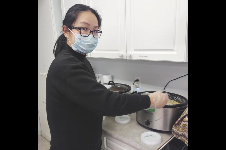 Diana Woon prepared food for the community hot meals, which will now go back to being served in person at the Knox Hall, starting Nov. 6.