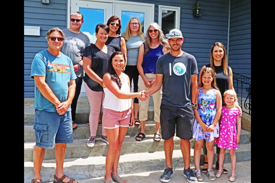 Staff and board members of the Family Place gathered at the launch of the project. From left are Kevin Melle, project manager; Nick Lumb, Judy Lumb, Andrea Stepp, Brenda Ziegler and Darla Peterson, with executive director Dawn Gutzke in front with contractor Chase Johnson, wife Whitney and daughters Sadie and Lainey.