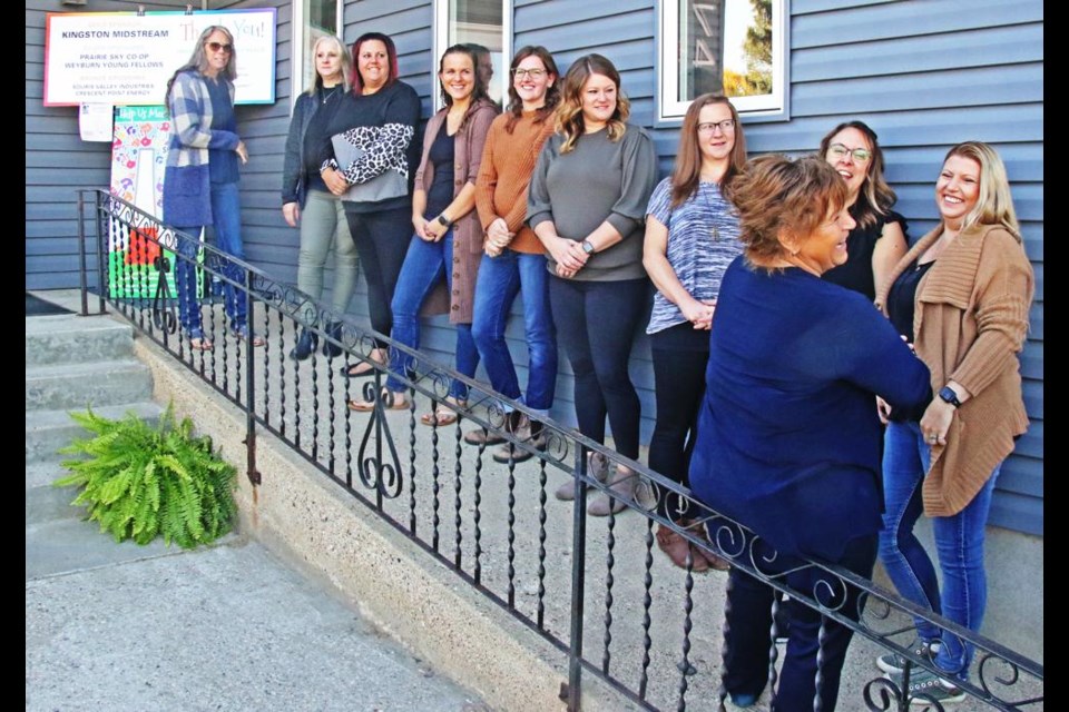 The Family Place staff lined up along the wheelchair ramp for the opening ceremonies at their new location on McLelland Street.