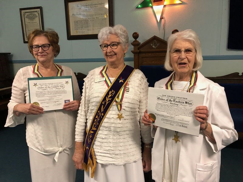 Sister Judy Stone, (centre) Worthy Matron, presented sister Nancy Leeson (left) to Grand Representative of Wyoming in the grand jurisdiction of Saskatchewan, and sister Marjorie Orr (right) as Grand Representative of Ohio, in the grand jurisdiction of Saskatchewan.