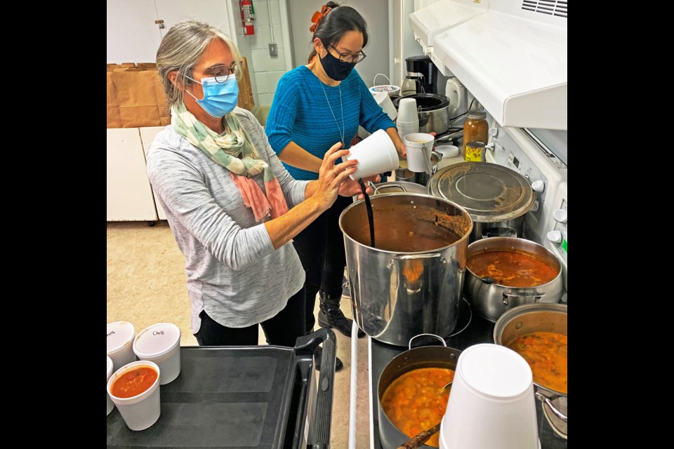 Volunteers Darla Peterson and Diana Woon prepared freshly-made food for delivery to people around the city on Sunday, with 65 meals delivered by 14 volunteer drivers.