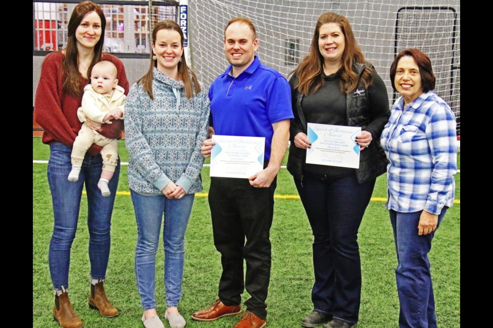 Representatives of Inclusion Weyburn presented Spirit of Inclusion Awards to City of Weyburn recreation staff on Friday afternoon. From left are Jada Messer with Grady, and Kim Neithercut, both of Inclusion Weyburn, award recipients Ryan Dale and Tina Clay, and Jackie Wilson of Inclusion Weyburn. Ryan is the leisure services director for the City, based at the Credit Union Spark Centre, and Tina is director of aquatic programs at the Weyburn Leisure Centre, and both were recognized for their role in assisting Inclusion children be a part of programs with the city.