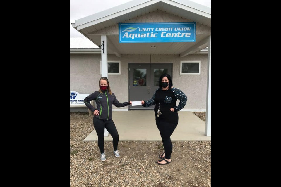 Unity Kin Club President, Amanda Whyte, makes a donation on behalf of the club to Unity Parks and Rec. Director, Nicole Headrick, for new equipment at the pool