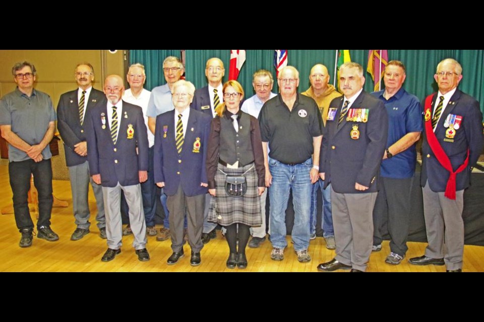 Recipients of service awards for the Weyburn branch of the Royal Canadian Legion gathered after the presentations on Monday evening. In the back row from left are Brad Irwin, Patrick Elkington, Willard Marr, Don Schmidt, Mel Van De Sype, Garth White, Philip Babiarz, Larry Eskdale, and Sgt.-at-arms Owen White. In front are Jerry Ponto, chaplain Marjorie McLeod, Dyana Wright, Robert Milligan and Harold Whiteoak. A number of recipients were not able to be present for the awards, please see the story for the full list of awards.