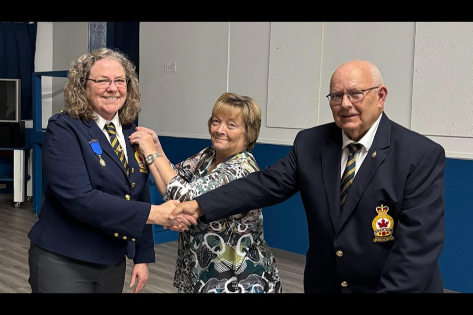 Presenting the Past President's medal and pin to President Cathy L. Trach of the Canora branch of the Royal Canadian Legion were Pat Thompson, past president and Thomas Carnahan, honours and awards chairperson.