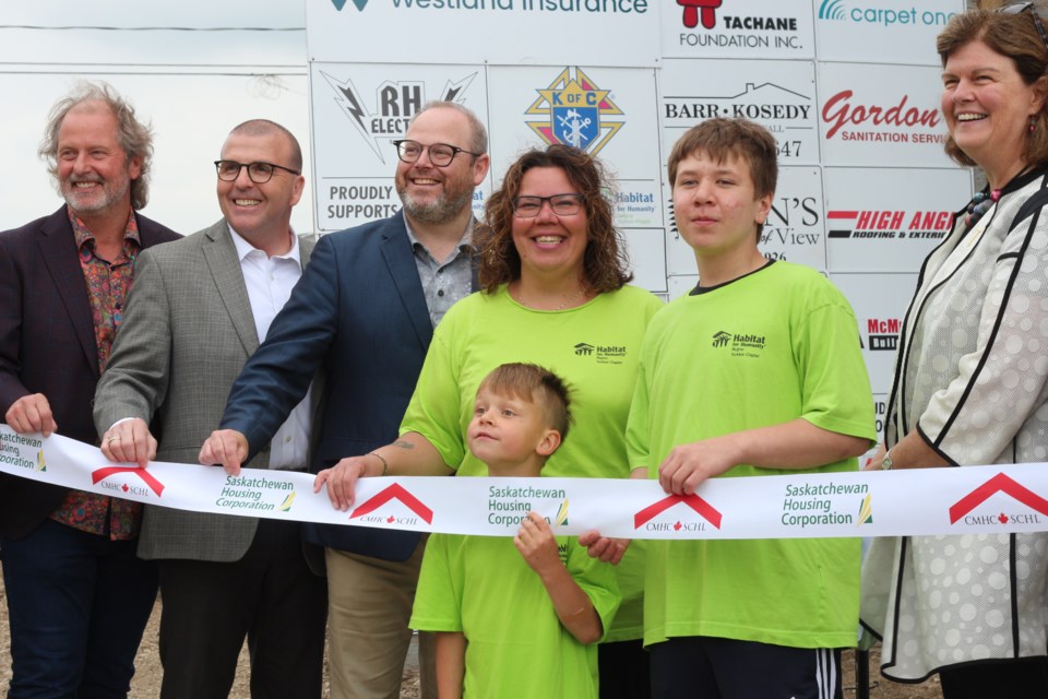 Tania Fleury (center), pictured here with sons Christian and Lane, Mayor Mitch Hippsley (left), MLA Greg Ottenbreit, Denis Perrault CEO of Habitat for Humanity Saskatchewan and Julia Deans (right) CEO of Habitat for Humanity Canada.