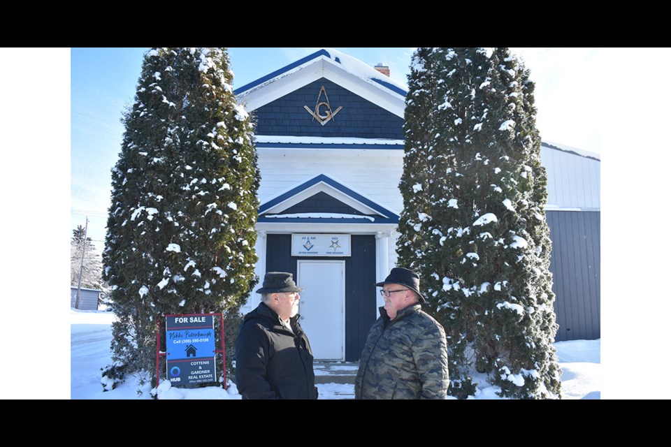 Last week, Rick Aikman, left, the Masons’ Worshipful Master, and Craig Currie, secretary-treasurer, met at the front steps of the Masonic Hall on main street in Kamsack, where a sign indicates that the building, which had served the group since 1945, is now for sale.