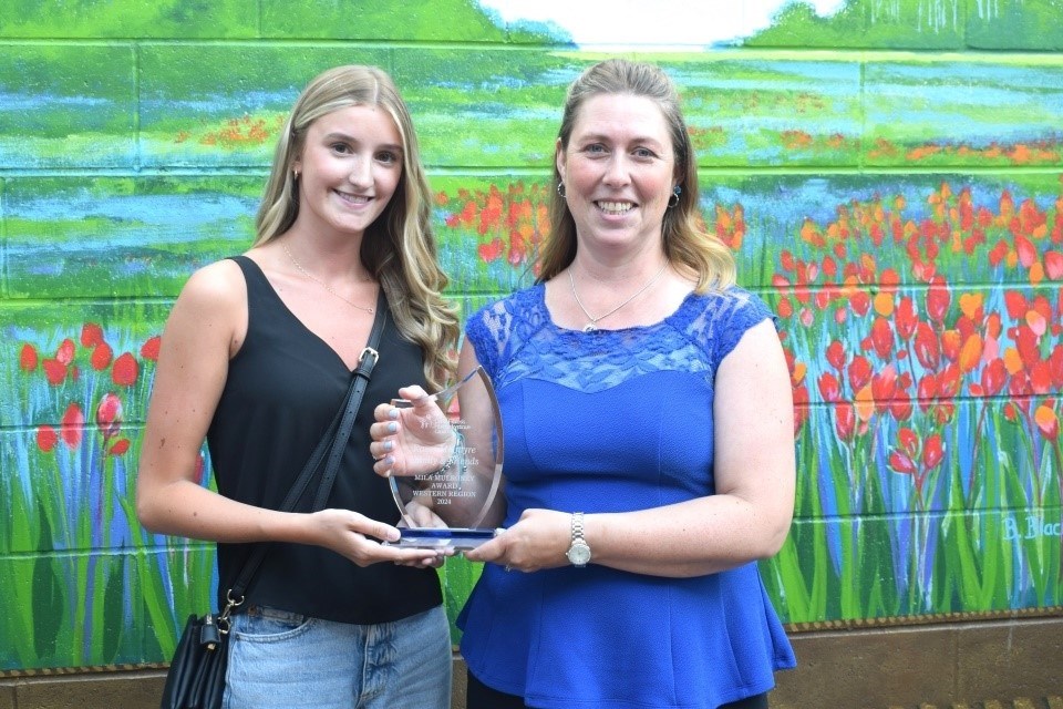 From left, Teresa Weger from Cystic Fibrosis Canada presents the award to Kasey McIntyre. 