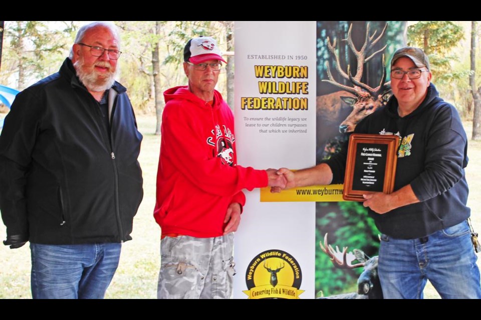 Larry Olfert and Kelly Kozij of the Weyburn Wildlife Federation presented Morley Forsgren with the Fred Garner Memorial Award for Outstanding Member of the Wildlife Federation for 2019.
