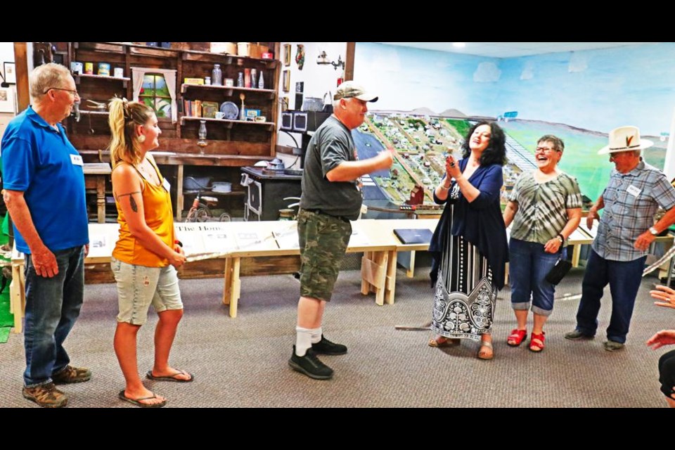 Pangman Mayor Boyd Tourscher, centre, cut the ribbon to officially open the Pangman Museum. From left are board member Ed Howse, vice-chair Lexi Keller, chair Jacquie Mallory, secretary Arlene Howse and treasurer Gene Kessler.