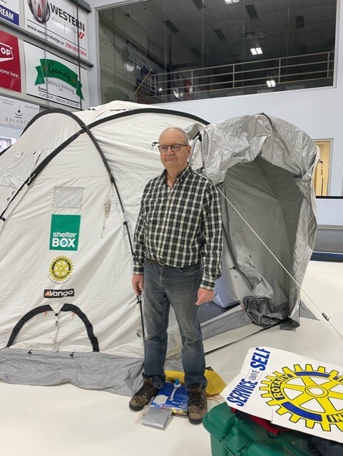 Rotary Club member Walter Hutchinson with a Shelter Box tent.