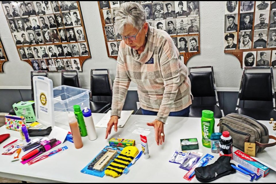 Weyburn Rotary member Gwen Wright shows the items that are going into the children's kits, in addition to those for women (at left) and for men.